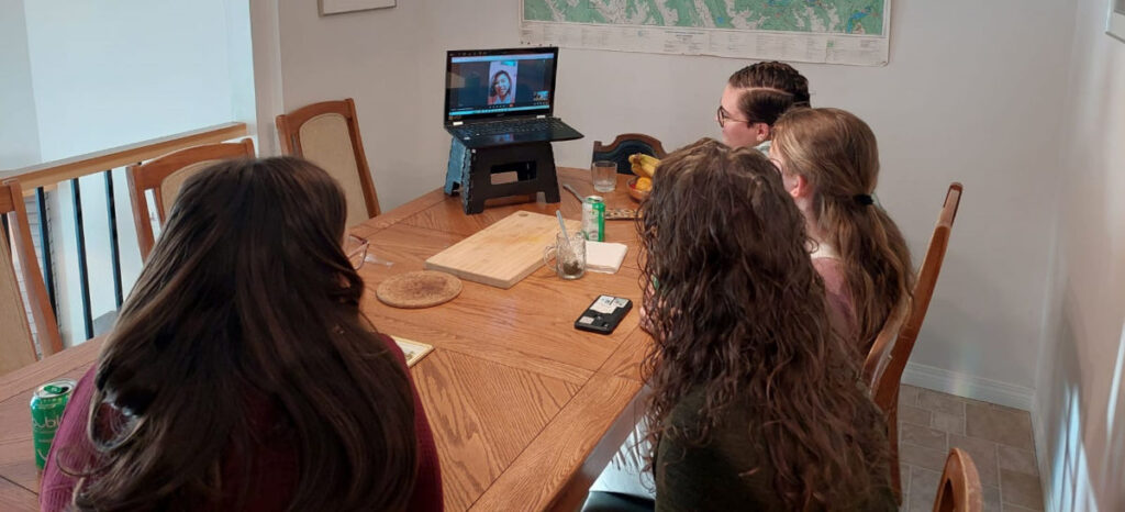 School of Discipleship students video calling with Spanish teacher